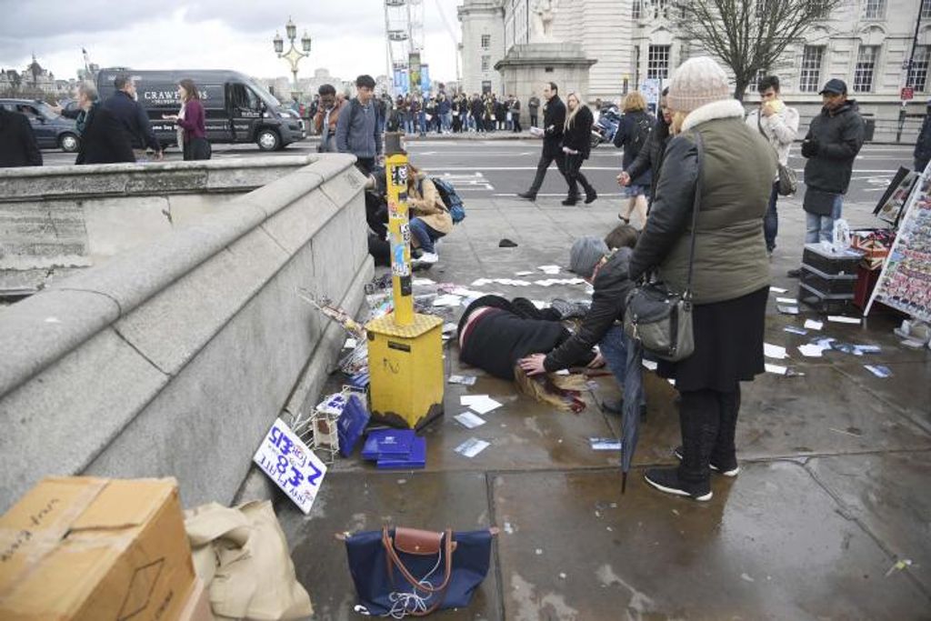 Injured people are assisted after an incident on Westminster Bridge in London