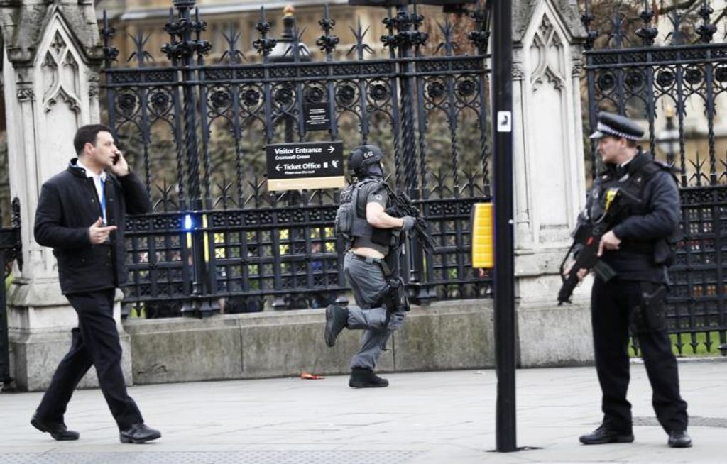 Armed police respond outside Parliament during an incident on Westminster Bridge in London