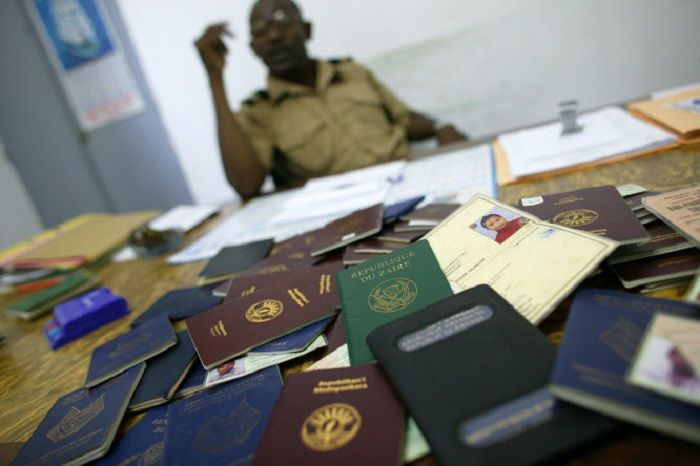 Picture taken 15 October 2005, of fack identity carde and confiscated passeports from differents country at Immigration office in Mutsamudu, Comoros archipelago. Comorans on rickety vessels frequently die attempting to make the 50-kilometer (30-mile) trip from Anjouan to illegally enter France through Mayotte, which is more developed that the impoverished coup-plagued archipelago on which they live. AFP PHOTO RICHARTD BOUHET