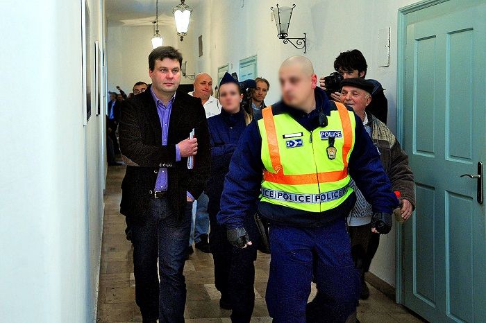 Esztergom, 2011. november 25. Meggyes Tamás, Esztergom volt polgármestere, fideszes önkormányzati képviselõ rendõri biztosítással elhagyja az üléstermet a képviselõ-testületi ülés végén, ahol a képviselõk megszavazták a közétkeztetés és a közvilágítás újraindítására szolgáló összeget. 2011. november 24-én a városon átvezetõ 10-es és 11-es fõút belterületi szakaszán kapcsolta ki a közvilágítást Tivi Kft, a HunGast Esztergom Kft. pedig 2011. november 23-án megszüntette a közétkeztetést a városi gyermekintézményekben az önkormányzat tartozása miatt. A helyi képviselõ-testület korábban határozatképtelenség miatt nem tudott dönteni a szolgáltatók számláinak kifizetésérõl. MTI Fotó: Kovács Attila